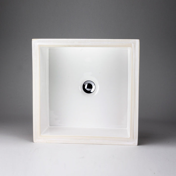 White square Acritec undermount ceramic basin with flat bottom beneath a stylish countertop