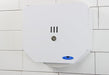 Frost 166 white steel jumbo toilet tissue dispenser in use