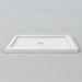 White Acritec low profile single threshold shower base with center drain in a modern alcove installation