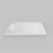 White Acritec linear end drain low profile double threshold shower base with LH stainless grill in an industrial bathroom